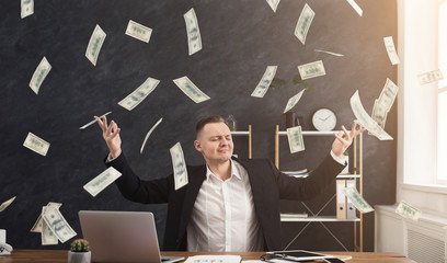 Happy businessman and flying dollar banknotes