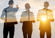 © rh2010 - Silhouettes of business people standing back on the landscape background with wind turbines during the sunset. Double exposure image technic