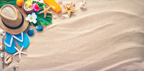 Straw hat with a exotic cocktail and sunglasses on sand beach Wallpaper Mural