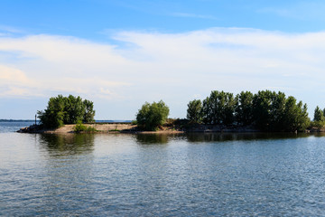 Summer landscape with beautiful lake, green trees and blue sky