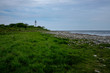 © Kilman Foto - green grass stones and a lighthouse in the background