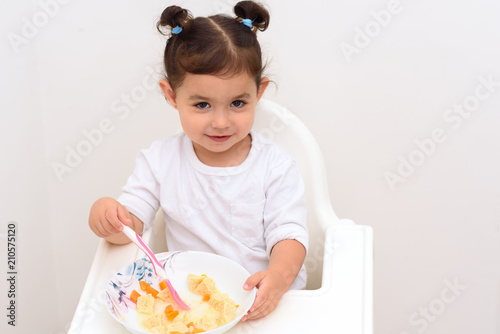 Smiling Adorable Girl With Funny Pigtails Eat Soup With