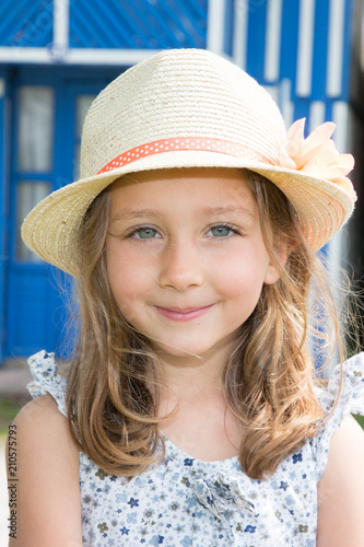 Cute Child With Blond Hair In A Straw Hat In Garden Buy This
