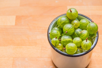 Green gooseberry fruit closeup isolated on wooden background. Fresh ripe gooseberry.diet, vegetarianism, vegan food, organic berries