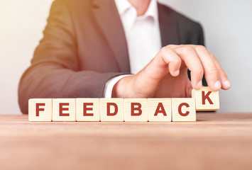 Poster - man made word feedback with wood blocks