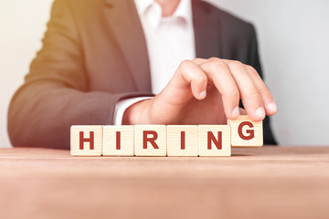 Poster - man made word hiring with wood blocks