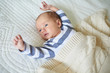 © Ekaterina Pokrovsky - One month baby girl lying under knitted blanket