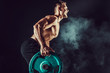 © zamuruev - Strong athletic man pumping up muscles workout bodybuilding. muscular bodybuilder handsome men doing exercise for muscles of back with a barbell on dark background with smoke. Strength and motivation.