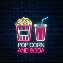 Wall Mural - Neon glowing sign of pop corn and soda on a dark brick wall background. Cinema fastfood light billboard symbol.