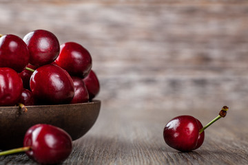 Wall Mural - Fresh Ripe Cherries in a rustic wooden bowl