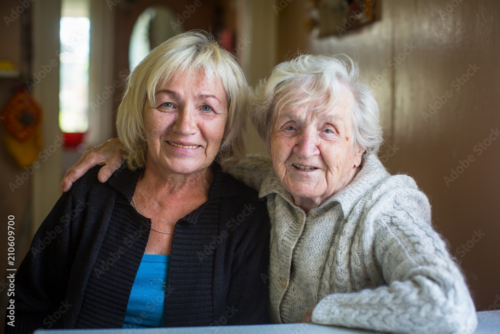 An elderly woman with her adult daughter. - obrazy, fototapety, plakaty 