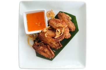 Wall Mural - Fried chicken wings with sauce in white plate  isolated on white background..