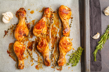 Wall Mural - Grilled spicy chicken legs baked with garlic, rosemary and thyme on the pan.