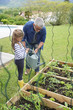 Father and daughter gardening together, home vegetable garden