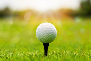 Sticker - Close up White Golf ball on tee ready to be shot in soft focus at sunlight with bokeh.