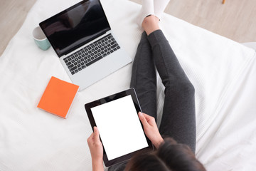 Poster - top view woman use tablet,laptp working online on bed in bedroom at home.mock up template device screen.Digital lifestyle  concept.