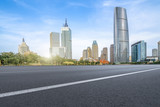 Fototapeta Nowy Jork - The empty asphalt road is built along modern commercial buildings in China's cities.
