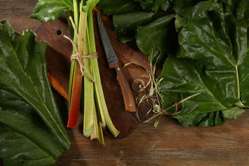 Wall Mural - Chopping fresh rhubarb on wood