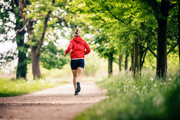 Wall Mural - Running woman, enjoying summer day in park