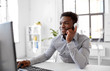 © Syda Productions - business, technology and people concept - happy african american businessman with headphones and computer listening to music at office