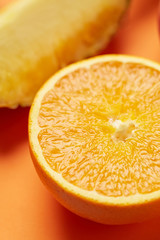 Wall Mural - Juicy and ripe sweet vegetarian slice orange on yellow background, close up