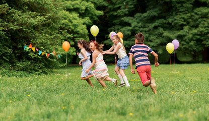 Poster - friendship, childhood, leisure and people concept - group of happy kids or friends playing tag game at birthday party in summer park