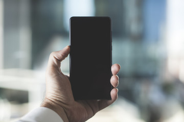 Hand holding black smart phone