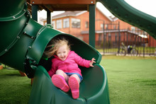 Cute Little Girl Having Fun On Outdoor Playground