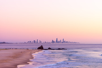 Currumbin Rock with the Gold Coast skyline at sunrise with a pink sky