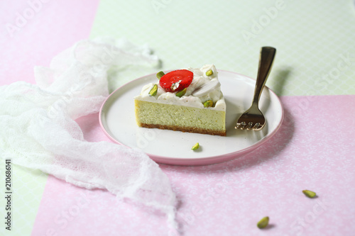 Cuadros en Lienzo Piece of Pistachio Cheesecake with Vanilla Diplomat Cream, on light green and pink background