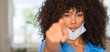 © Krakenimages.com - African american woman medical professional pointing with finger to the camera and to you, hand sign, positive and confident gesture from the front