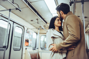 Wall Mural - Young romantic couple in subway