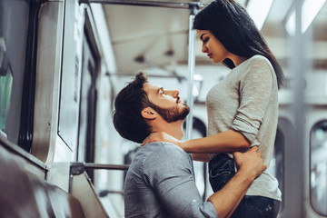 Wall Mural - Young romantic couple in subway