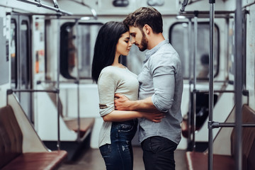 Wall Mural - Young romantic couple in subway