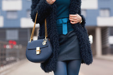 Street, Bright Style. A Young Girl In A Blue Fur Coat With A Handbag In Heels. Details.