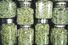 Marijuana Buds In Glass Jar Stack