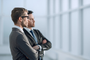 business partners talking near the office window