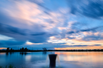 Wall Mural - The oil pumping units  and cloudscape sunset.