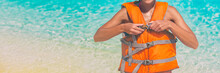 Watersport Woman Putting On Orange Life Jacket For Satefy On Ocean Activity. Panorama Banner Header Crop. Sport Lifestyle.