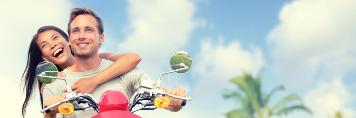 Wall Mural - Couple tourists travel fun riding scooter for road trip summer vacation. Banner panoramic landscape header crop. Smiling young woman, man in love.