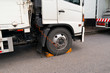 Park and safety..Professional truck services using wheel stoppers when parking for safety operation, safety concept.
