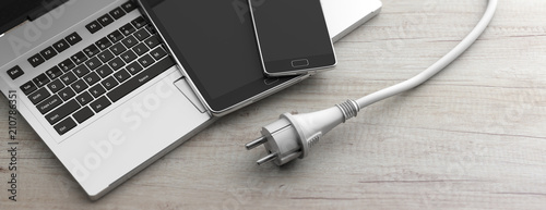Fotografía Computer, laptop, smartphone and power plug on wooden background