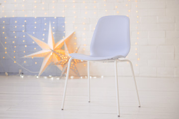 A blue modern elegant chair in the  interior  with the lights on the background.