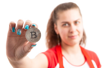 Poster - Young woman retailer or sales assistant holding bitcoin symbol.