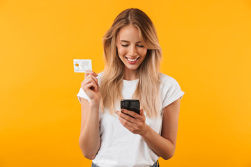 Poster - Portrait of a happy young blonde girl showing plastic credit