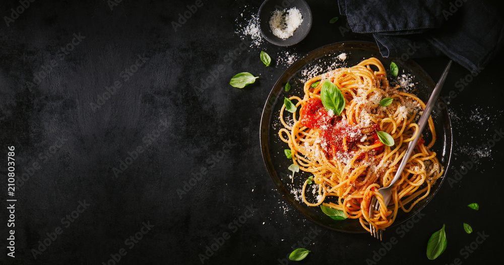 Dark plate with italian spaghetti on dark - obrazy, fototapety, plakaty 