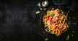 Leinwandbild Motiv Dark plate with italian spaghetti on dark