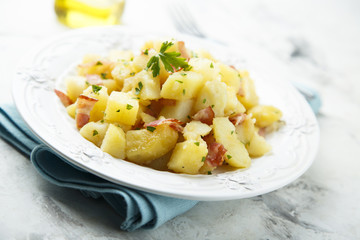 Canvas Print - Homemade warm potato salad with onion and fried bacon