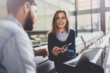 Teamwork concept.Young creative coworkers working with new startup project in modern business center.Group of two entrepreneur making discussion.Blurred background.