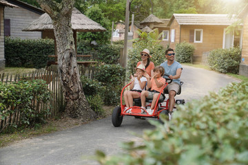 Wall Mural - Parents with kids having fun riding kart